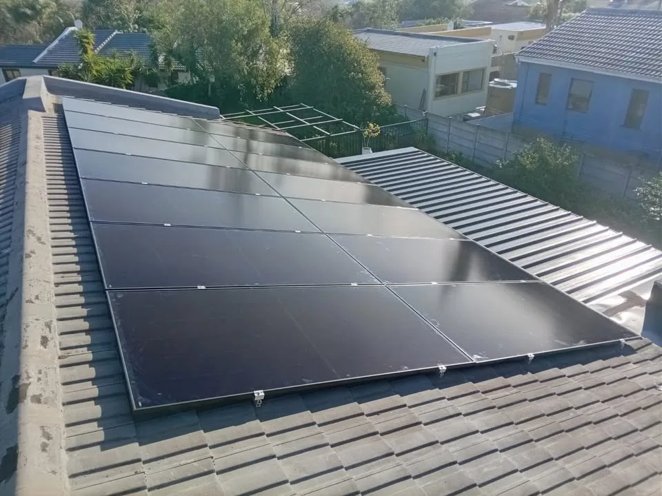 Full-black solar panels installed by MLT Power on a tiled Cape Town roof, ready for SSEG registration